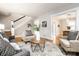 Open-concept living room with hardwood floors, comfortable seating, and staircase in view at 622 E 37Th St, Indianapolis, IN 46205