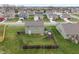 Aerial view of a home's fenced backyard with a play set, offering a secure and fun outdoor space at 6316 Avacado Dr, Indianapolis, IN 46217