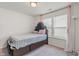 Sunlit bedroom featuring a classic headboard, soft carpet, and natural light at 6316 Avacado Dr, Indianapolis, IN 46217