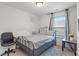 Bedroom features neutral carpet, a large window, and minimalist decor at 6316 Avacado Dr, Indianapolis, IN 46217