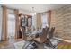 Elegant dining room featuring modern chairs, a glass table, and decorative display cabinet at 6316 Avacado Dr, Indianapolis, IN 46217