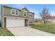 Lovely two-story home with a two-car garage and long drive on a sprawling lawn at 6316 Avacado Dr, Indianapolis, IN 46217