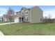 A charming two-story home with lush lawn and attached two-car garage on a sunny day at 6316 Avacado Dr, Indianapolis, IN 46217