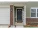 Close-up of the front door with brickwork, sidelight, and a welcoming entrance at 6316 Avacado Dr, Indianapolis, IN 46217