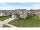 Two-story home featuring a spacious front yard with a beautiful lawn and a large driveway at 6316 Avacado Dr, Indianapolis, IN 46217