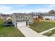 Beautiful home with a spacious driveway, well-maintained lawn, and inviting curb appeal at 6316 Avacado Dr, Indianapolis, IN 46217