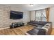 Comfortable living space featuring a mounted TV, vinyl floors, and a dark sectional at 6316 Avacado Dr, Indianapolis, IN 46217