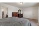 A view of the main bedroom with a large bed, neutral carpet, and a dark wood dresser at 6316 Avacado Dr, Indianapolis, IN 46217