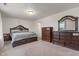 Spacious main bedroom with neutral carpet, dark wood furniture, and ample natural light at 6316 Avacado Dr, Indianapolis, IN 46217