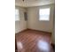 Bedroom featuring two windows for natural light and wood floors, offering a simple and comfortable living space at 6389 N Forest St, Martinsville, IN 46151
