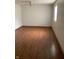 Bright bedroom with hardwood floors, a ceiling fan, and two windows providing natural light, creating a comfortable space at 6389 N Forest St, Martinsville, IN 46151