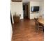 Dining area with wood floors, a wooden table and chairs, and views into other rooms, showcasing a spacious layout at 6389 N Forest St, Martinsville, IN 46151