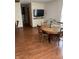 Dining room features a round wooden table with chairs, a TV, and wood floors, perfect for Gathering meals at 6389 N Forest St, Martinsville, IN 46151