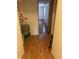 Hallway with wood floors leading into another room, showing the interior layout and design of the home at 6389 N Forest St, Martinsville, IN 46151