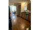 Traditional kitchen with a sink, wood cabinets, and an open view to a dining area, creating a functional and welcoming space at 6389 N Forest St, Martinsville, IN 46151