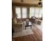 Cozy living room features wood-paneled walls, neutral furniture, and natural light, creating a warm and inviting space at 6389 N Forest St, Martinsville, IN 46151
