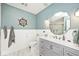 Charming bathroom with a nautical theme, a vanity with drawers, a decorative mirror and tiled floors at 6436 Lakeland Blvd, Indianapolis, IN 46234