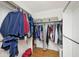 Organized walk-in closet with wooden floors and ample storage space, perfect for keeping clothes neat and tidy at 6436 Lakeland Blvd, Indianapolis, IN 46234