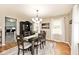 Bright dining room with hardwood floors and an accent rug beneath the matching dining set at 6436 Lakeland Blvd, Indianapolis, IN 46234