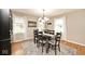 Traditional dining room features hardwood floors, natural light, modern light fixture, and accent rug at 6436 Lakeland Blvd, Indianapolis, IN 46234