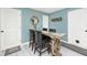 Rustic dining area is complete with round mirror and wooden table and chairs at 6436 Lakeland Blvd, Indianapolis, IN 46234