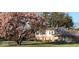 Attractive home with a blossoming tree, manicured lawn, and a well-maintained exterior at 6436 Lakeland Blvd, Indianapolis, IN 46234