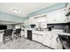 Bright and updated kitchen with white cabinets and dark tile backsplash under an accent wall at 6436 Lakeland Blvd, Indianapolis, IN 46234