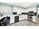 Renovated kitchen featuring stainless steel appliances, white cabinets, and granite countertops at 6436 Lakeland Blvd, Indianapolis, IN 46234