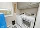 Bright laundry room with modern washer and dryer, storage cabinets and natural light at 6436 Lakeland Blvd, Indianapolis, IN 46234