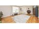 Spacious living room with hardwood floors, large window, and stylish decor at 6436 Lakeland Blvd, Indianapolis, IN 46234