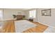 Bright living room with hardwood floors, a large window, and neutral paint at 6436 Lakeland Blvd, Indianapolis, IN 46234
