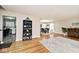 Open-concept living room with hardwood floors connecting the dining room and kitchen at 6436 Lakeland Blvd, Indianapolis, IN 46234