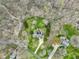 This aerial view shows a home with solar panels surrounded by woodlands and a long driveway at 6761 E Woodland Ct, Mooresville, IN 46158