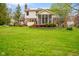 Back exterior with a screened-in porch overlooking the lush backyard, perfect for entertaining or relaxing outdoors at 6761 E Woodland Ct, Mooresville, IN 46158