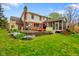 Expansive backyard featuring a screened-in porch, large deck and beautiful flower beds, ideal for outdoor living at 6761 E Woodland Ct, Mooresville, IN 46158