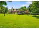 Expansive lush backyard featuring a well-maintained lawn and mature trees surrounding the property at 6761 E Woodland Ct, Mooresville, IN 46158