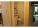 Cozy half bathroom with a vanity, toilet, and neutral color scheme at 6761 E Woodland Ct, Mooresville, IN 46158
