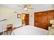 Bedroom features neutral decor, ceiling fan, door to the hallway and closet at 6761 E Woodland Ct, Mooresville, IN 46158