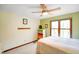 Bedroom with large window, hardwood trim and multi-colored bureau at 6761 E Woodland Ct, Mooresville, IN 46158