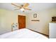 Bedroom features a ceiling fan, closet, shelving unit, and neutral colored walls at 6761 E Woodland Ct, Mooresville, IN 46158