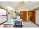 Large bonus room with vaulted ceiling, window, tv, and open door to hallway at 6761 E Woodland Ct, Mooresville, IN 46158