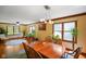 Dining area with wood table, chandelier, hardwood floors, and plants at 6761 E Woodland Ct, Mooresville, IN 46158