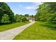 Charming brick home with a well-maintained lawn and long driveway at 6761 E Woodland Ct, Mooresville, IN 46158