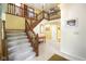 Bright foyer with hardwood staircase and ceramic tile flooring at 6761 E Woodland Ct, Mooresville, IN 46158