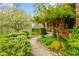 Charming front entrance with lush landscaping and a pathway to a cozy, covered porch with seating at 6761 E Woodland Ct, Mooresville, IN 46158