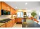 Well-lit kitchen featuring granite countertops, wood cabinets, stainless steel appliances and a gas cooktop at 6761 E Woodland Ct, Mooresville, IN 46158