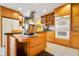 Kitchen with custom wood cabinets, island with granite countertop, and a built-in double oven at 6761 E Woodland Ct, Mooresville, IN 46158