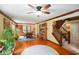 Open living area with hardwood floors, staircase, and multiple windows offering sunlight at 6761 E Woodland Ct, Mooresville, IN 46158
