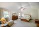 Relaxing main bedroom featuring a ceiling fan, dresser, bed, and ample natural light at 6761 E Woodland Ct, Mooresville, IN 46158