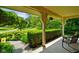 Relaxing covered porch with comfortable seating and a view of the landscaped yard at 6761 E Woodland Ct, Mooresville, IN 46158